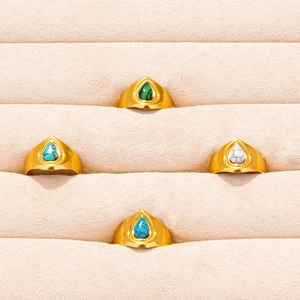 Set of four gold stainless steel rings featuring colorful teardrop-shaped gemstones
