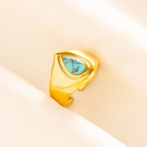 Detailed macro view of an adjustable gold signet ring featuring a teardrop turquoise stone