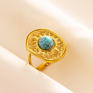Macro shot of gold bohemian ring featuring turquoise stone and hammered metal texture