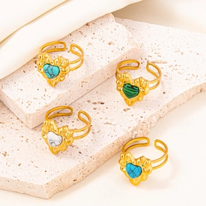 Detail of adjustable heart rings in four colors with irregular lava texture finish