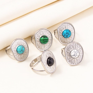 Set of five bohemian adjustable rings with colorful oval stones on ivory silk background