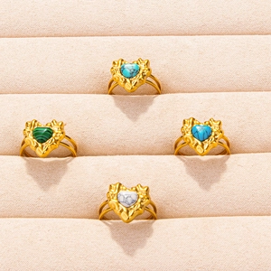 Set of four gold stainless steel textured rings with heart shaped colorful gemstones
