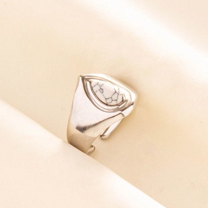 Close-up of a 304 stainless steel ring featuring a teardrop white turquoise stone inlay