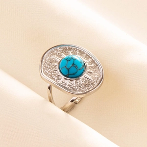Detailed macro of adjustable silver steel ring featuring turquoise stone and sunburst pattern