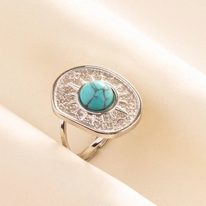 Detailed close-up of adjustable stainless steel ring with turquoise stone and sunburst pattern