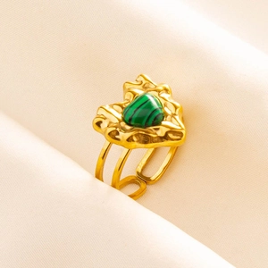 Macro detail of gold vintage 304 stainless steel ring with green malachite heart stone