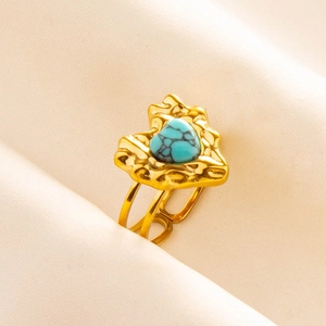 Detail of bohemian heart turquoise stone on gold lava texture stainless steel ring