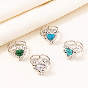 Detail view of four silver adjustable heart rings with malachite and marble stone inlays