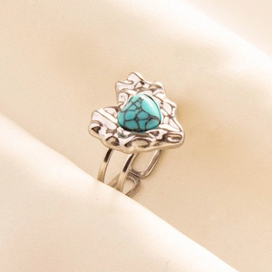 Macro detail of bohemian 304 stainless steel ring with turquoise heart and lava texture