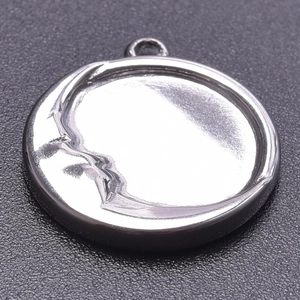 Macro shot of silver 304 stainless steel moon pendant with detailed 3D face relief