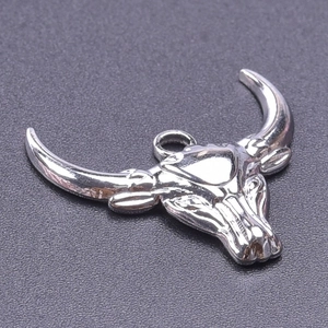 Macro shot of polished silver 304 stainless steel bull head pendant for DIY jewelry