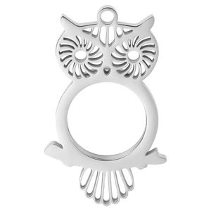 Macro shot of owl-shaped stainless steel pendant showing hollow design and silver texture