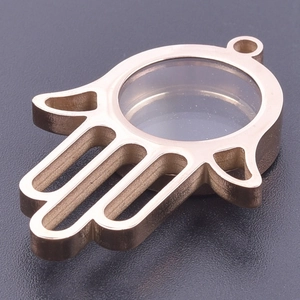 Macro detail of Hamsa Hand pendant with a central round photo frame in rose gold finish