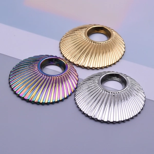 Macro detail of fluted cone metal pendants in gold, silver, and rainbow finishes for DIY jewelry