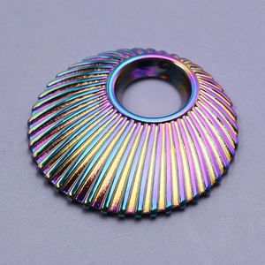 Macro view of iridescent 304 stainless steel shell charm with radial embossed texture
