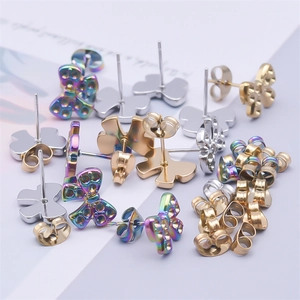 Detailed close-up of bow-shaped stud earrings set in gold, silver, and iridescent finishes