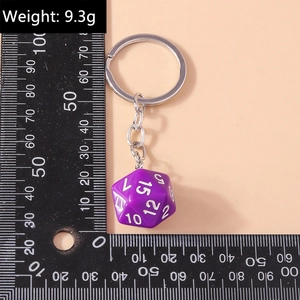 Macro shot of purple 20-sided D20 dice keychain with metal ring measuring 20mm on scale