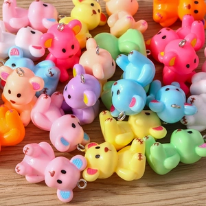 Macro shot of colorful resin bear pendants with metal loops for jewelry making