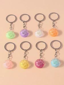 Flat lay of colorful swirl candy keychains in resin material with silver metal rings