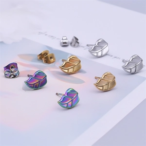 Detailed macro view of irregular leaf stud earrings in silver gold and rainbow finishes