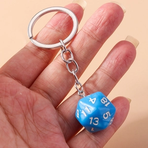Detail view of a blue 20-sided D20 dice keychain with white numbers and a silver metal ring