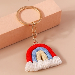 Macro detail of handmade rainbow keychain with colorful cotton cords and gold metal ring