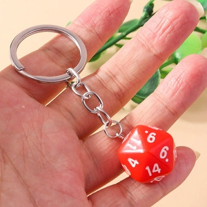 Close-up of a red 20-sided D20 gaming dice keychain with white engraved numbers