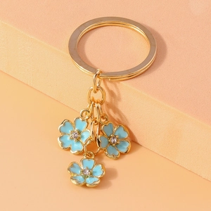 Detailed macro view of blue drip oil floral pendants with sparkling rhinestone inlay