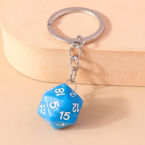 Close-up of a blue 20-sided D20 resin dice keychain with clear white numbers and silver ring