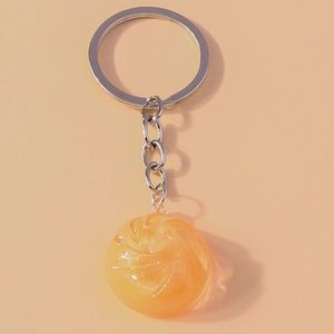 Macro shot of an orange translucent resin pendant with silver keychain ring