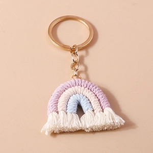 Detailed macro view of handmade woven rainbow keychain with purple cotton cords and gold ring