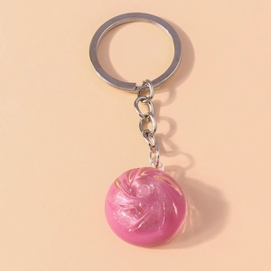 Detailed view of pink swirl crystal bun keychain with sparkling resin glitter effect