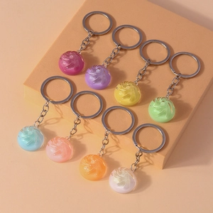 Detailed view of eight colorful crystal baozi keychains in various translucent pastel shades