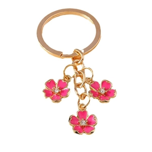 Pink cherry blossom keychain with gold metal plating and crystal accents for bags