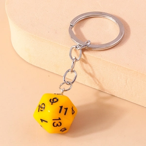Detail of creative yellow D20 dice keychain with silver metal chain and black numbers