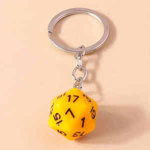 Macro shot of yellow 20-sided D20 dice keychain with clear black numbers and silver ring