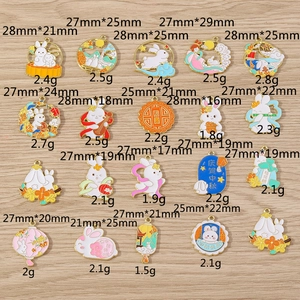 Detailed view of Chinese Mid-Autumn Festival enamel rabbit and mooncake charms for DIY jewelry