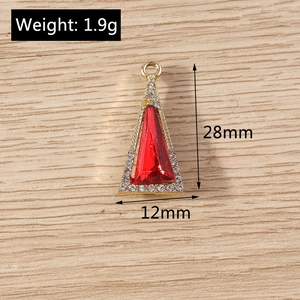 Macro detail of red triangle crystal pendant with gold frame and dimensions 28x12mm