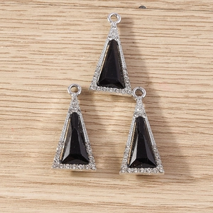 Macro detail of triangle crystal pendants with black stones and silver rhinestone borders