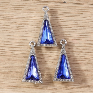 Detailed macro view of geometric triangle crystal pendants with blue stone and silver frame