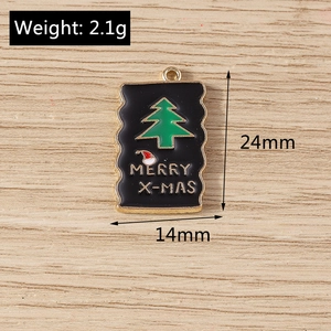 Detail showing height and width of alloy Christmas tree pendants on wood background