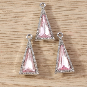 Macro shot of pink triangular crystal pendants with sparkling rhinestone border for DIY jewelry