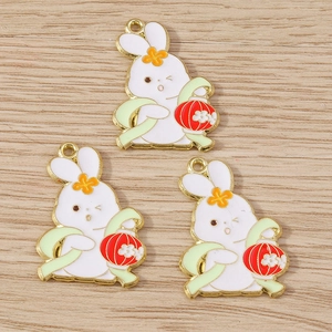 Close-up of enamel rabbit charms with red lanterns for DIY jewelry and necklaces