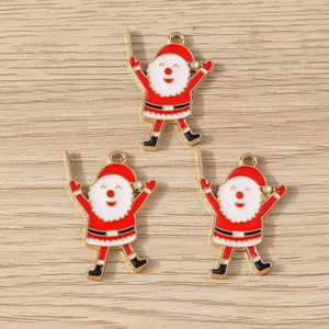Detail of three Santa Claus enamel charms with gold edges for DIY jewelry making