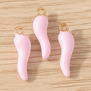 Detailed view of light pink chili pepper pendants with gold loops for DIY jewelry making