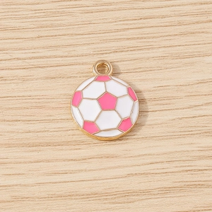 Detailed macro view of a pink and white enamel football pendant with a gold metal frame