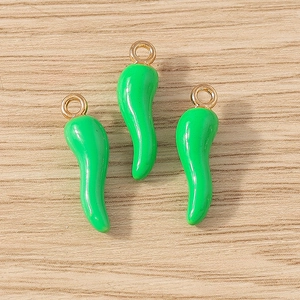 Green chili food charms with gold rings for DIY jewelry making on wood background