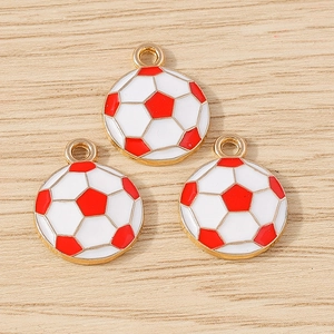 Macro detail of red and white football charms with gold edges and loop for DIY crafts