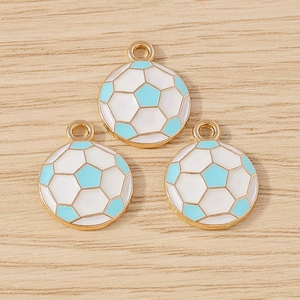 Three light blue and white soccer ball pendants with gold metal edges on wood surface