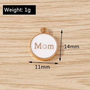 Detail showing a 11mm white enamel Mom charm with gold alloy edges on a wooden background